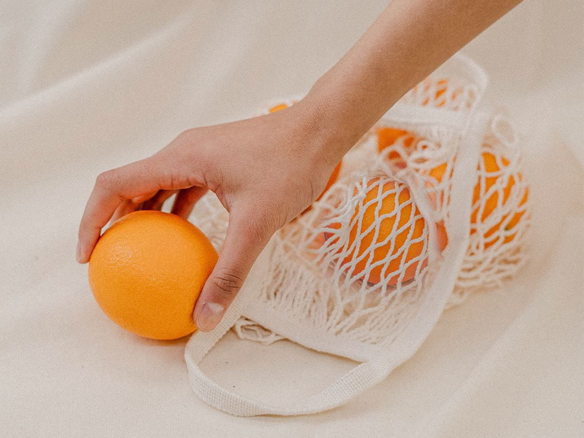 oranges in reusable shopping bag