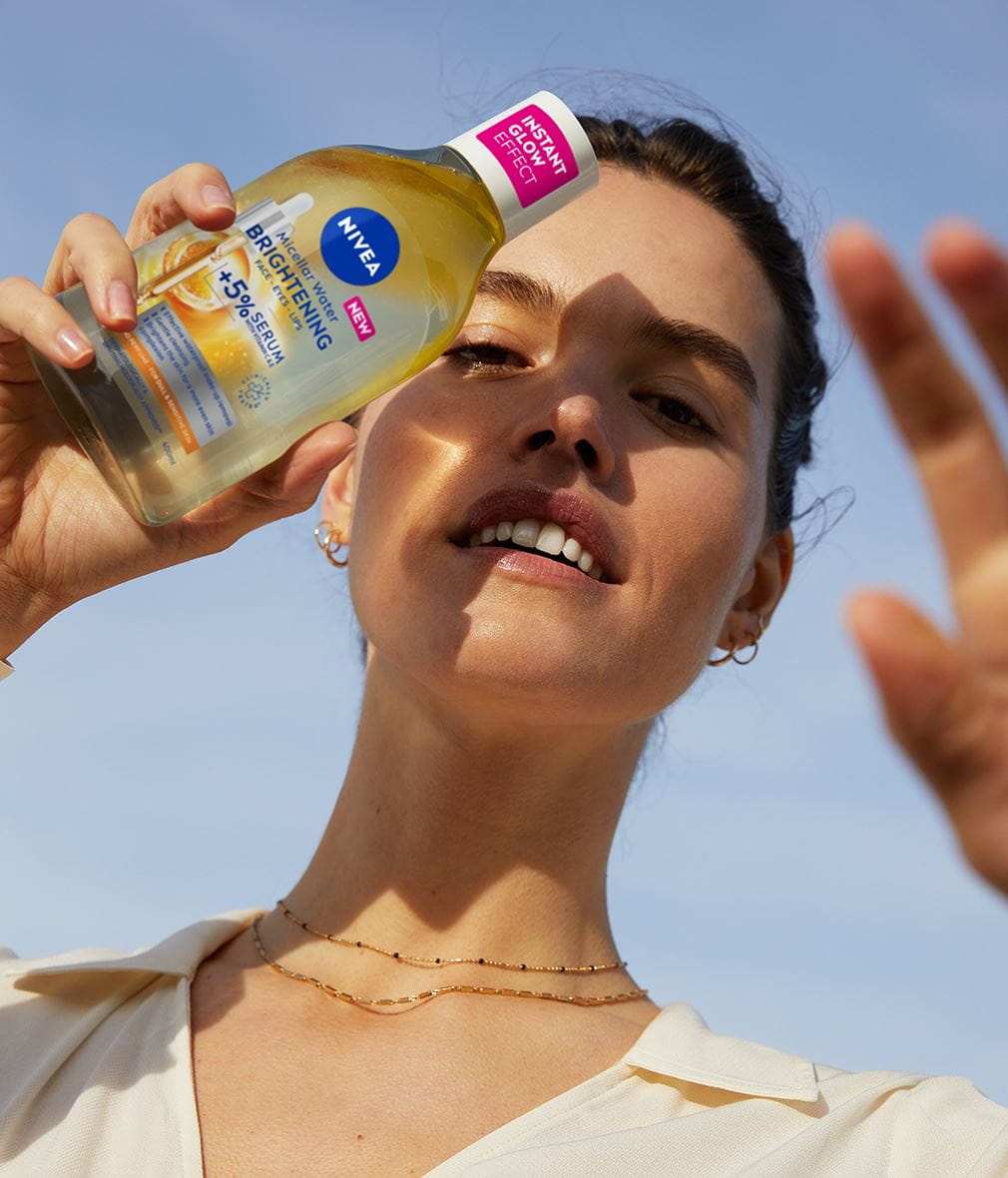 woman holding micellar water serum for bright skin