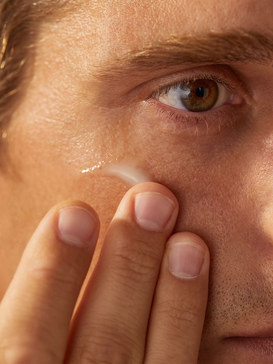 man applying Nivea face scrub gel
