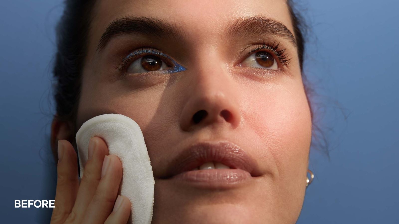 A close-up of a woman's face split down the middle, showing a "Before" on the left and an "After" on the right. The left side looks less radiant, while the right side appears more glowing and smooth. The background is a soft blue.