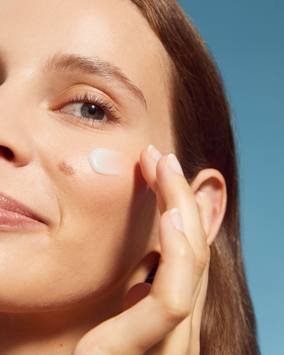 young woman using Nivea face cream