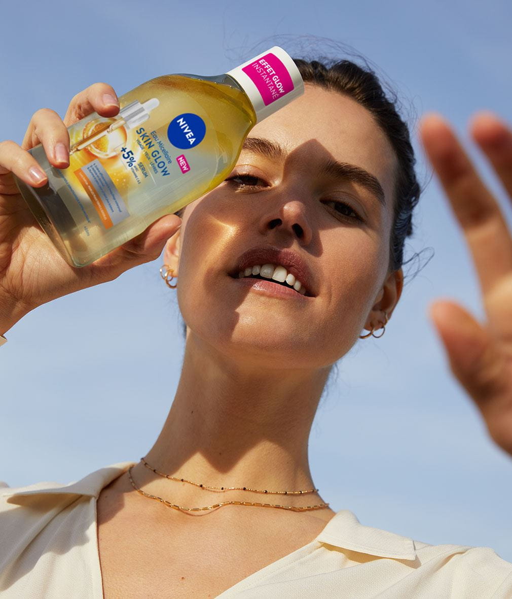 woman holding micellar water serum for bright skin