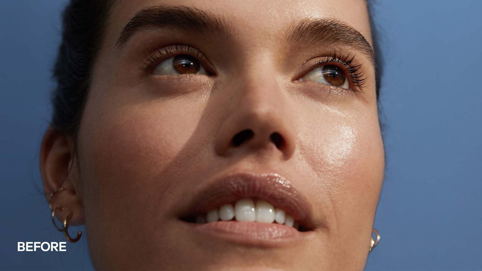 A close-up of a woman's face split down the middle, showing a "Before" on the left and an "After" on the right. The left side looks less radiant, while the right side appears more glowing and smooth. The background is a soft blue.