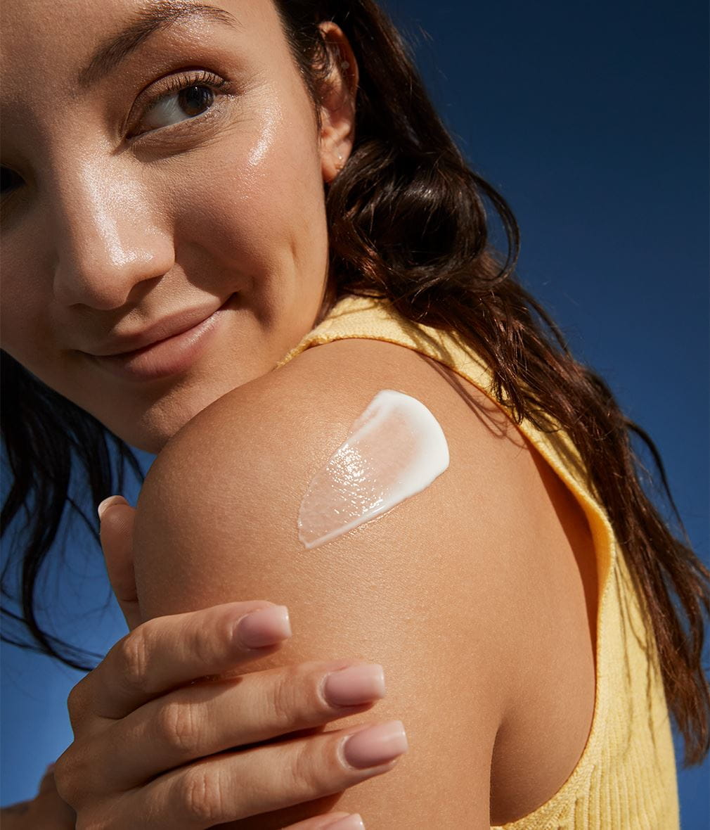 woman with NIVEA body lotion on her arm