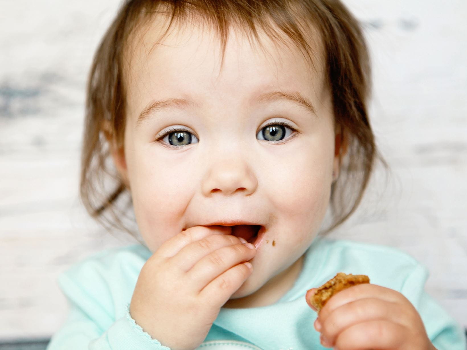 adorable-bébé-mangeant-un-biscuit