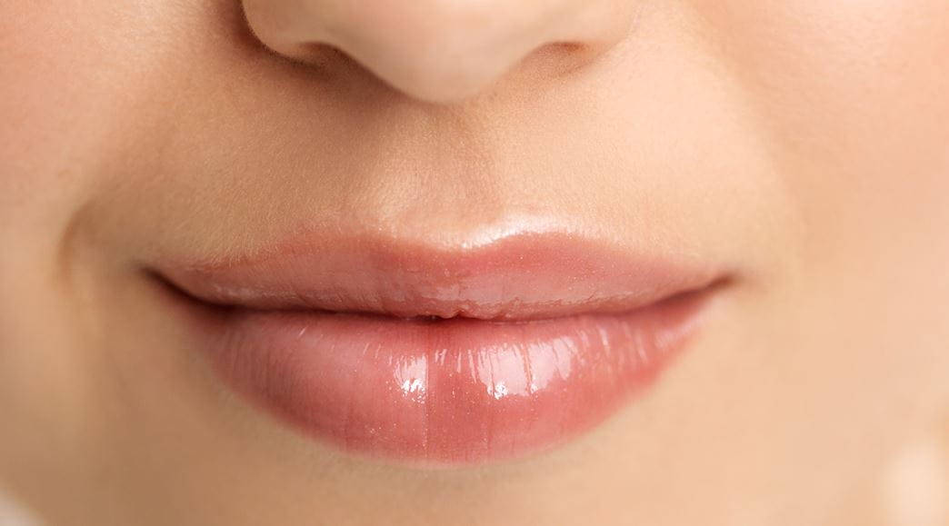woman using lip scrub 