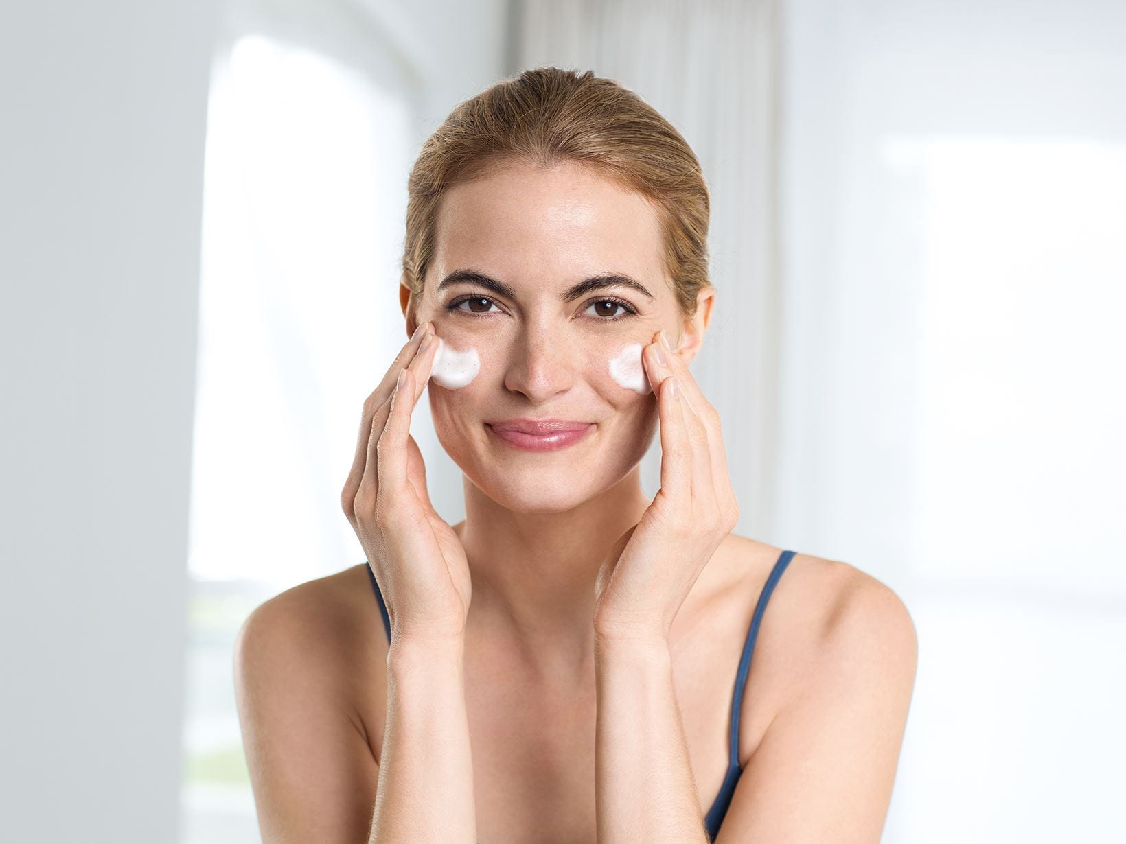 woman washing face with natural skin care tips 