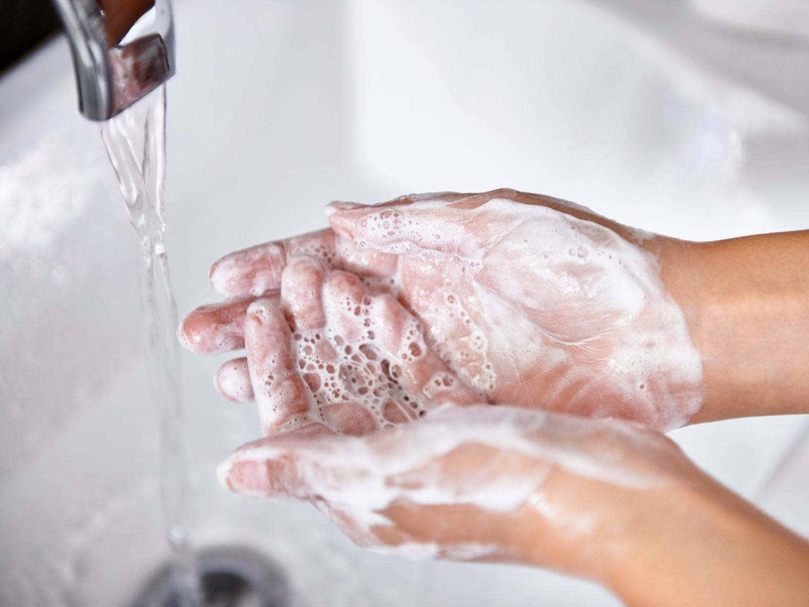 woman washing wrinkly hands 