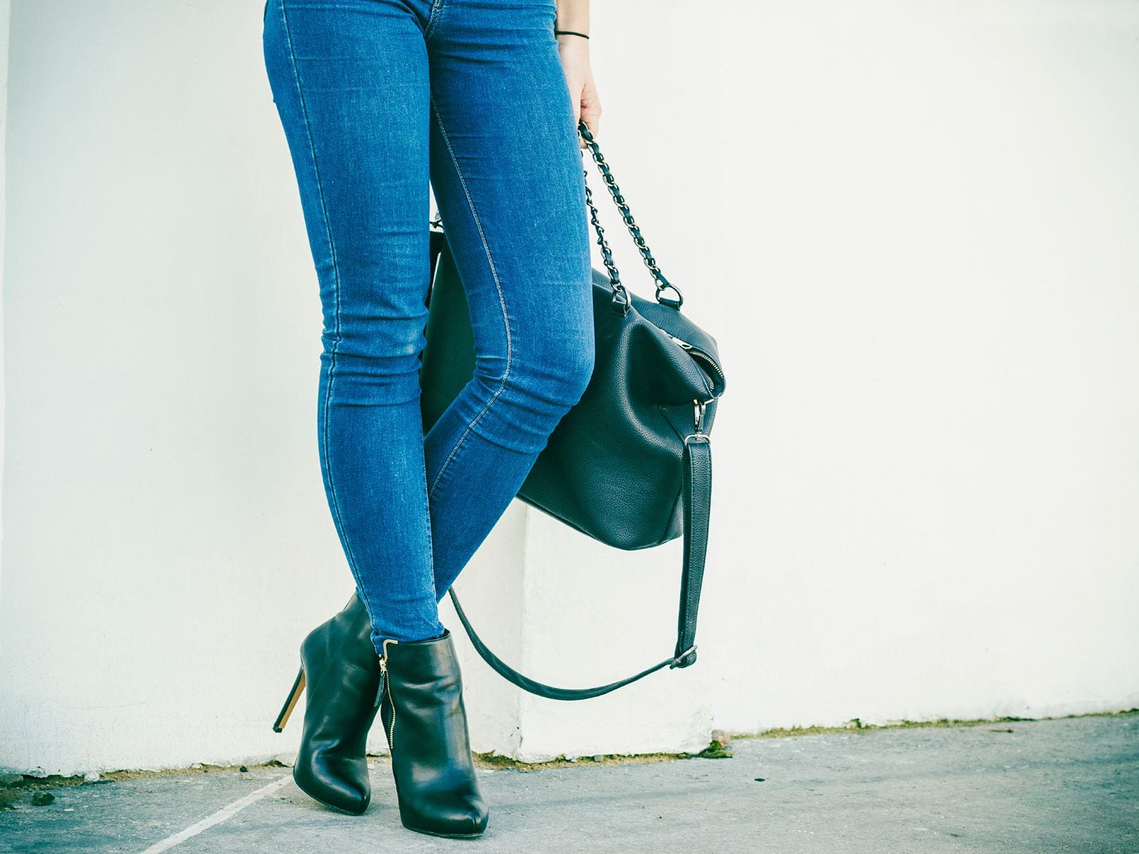 women wearing jeans with bag