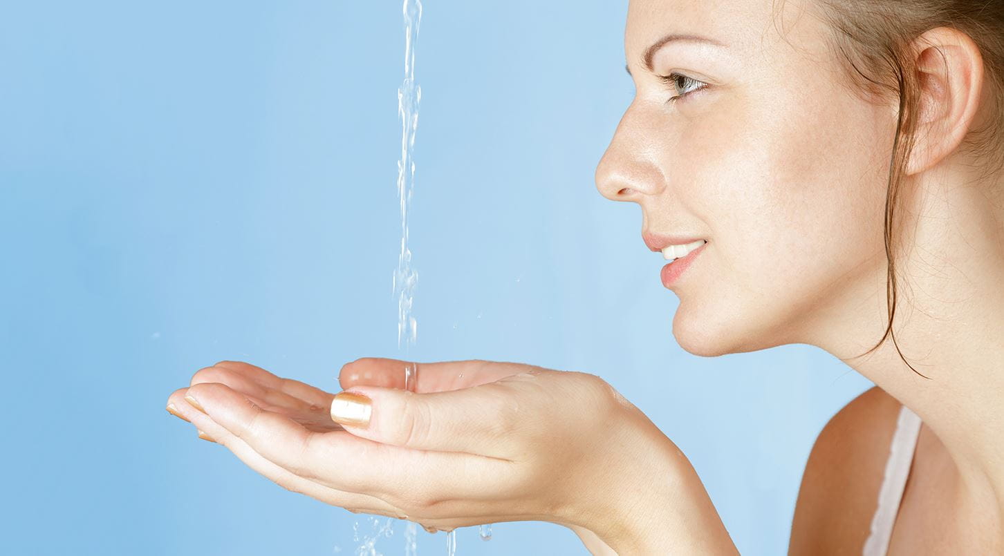 water pouring into womans hands