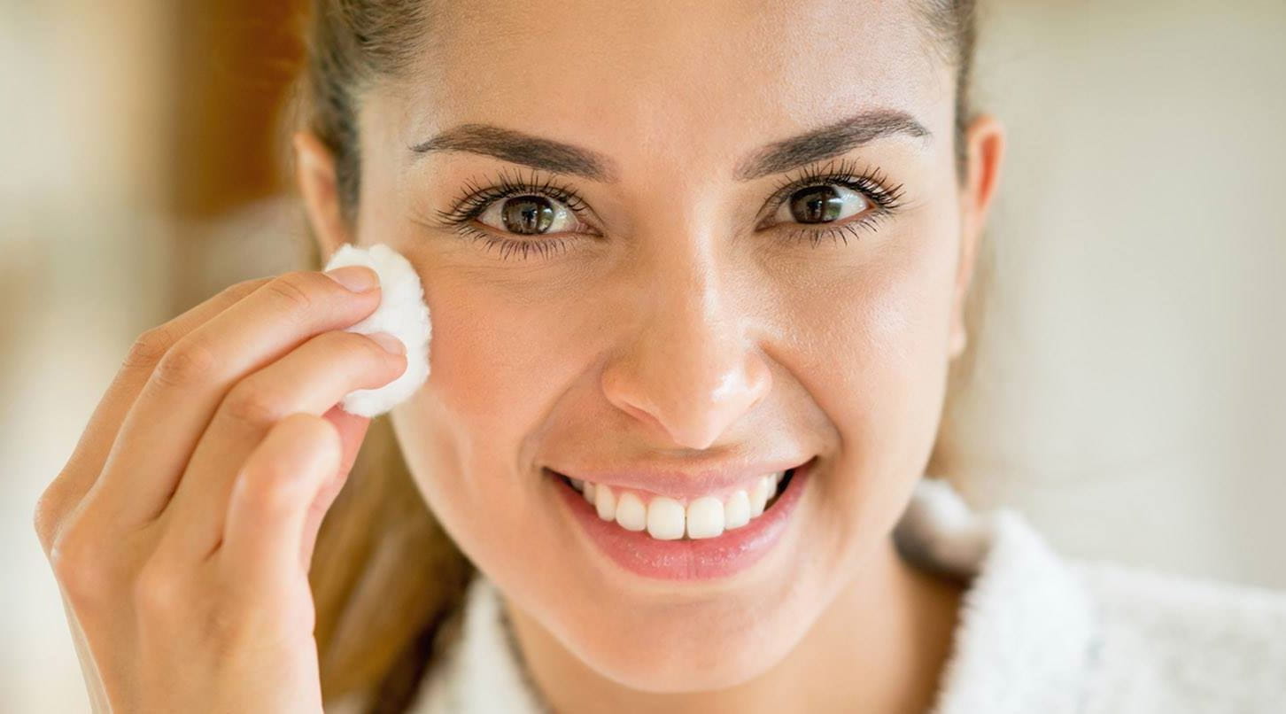woman using a dry oil based makeup remover