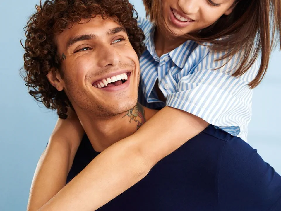 smiling lady exfoliating her skin