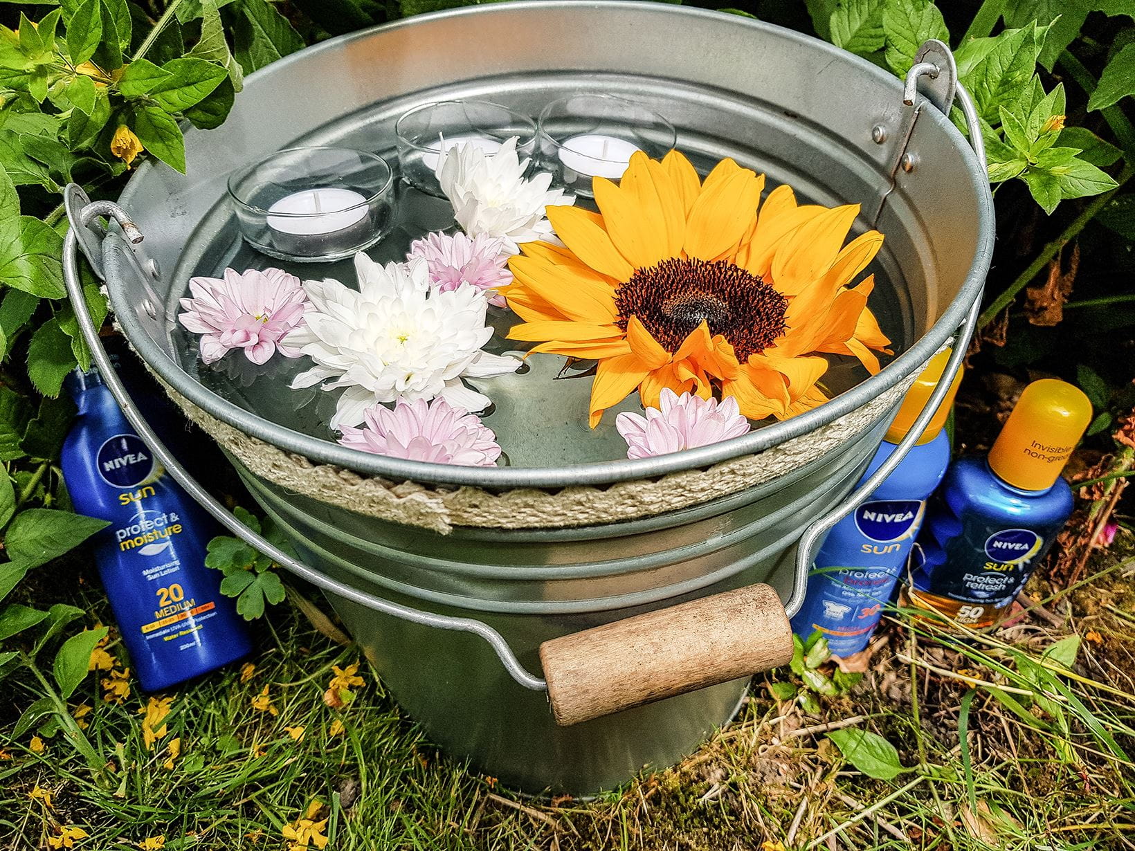 decorative-bucket-with-flowers-and-candles