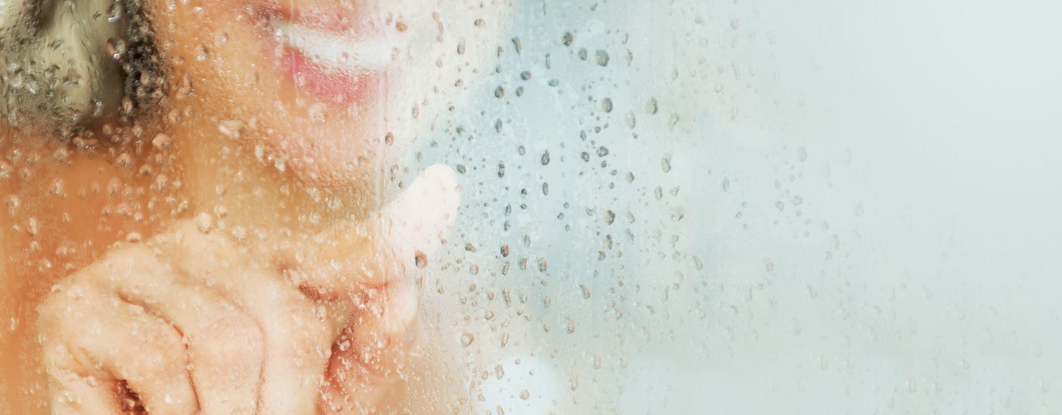 woman-behind-glass-shower-door-header