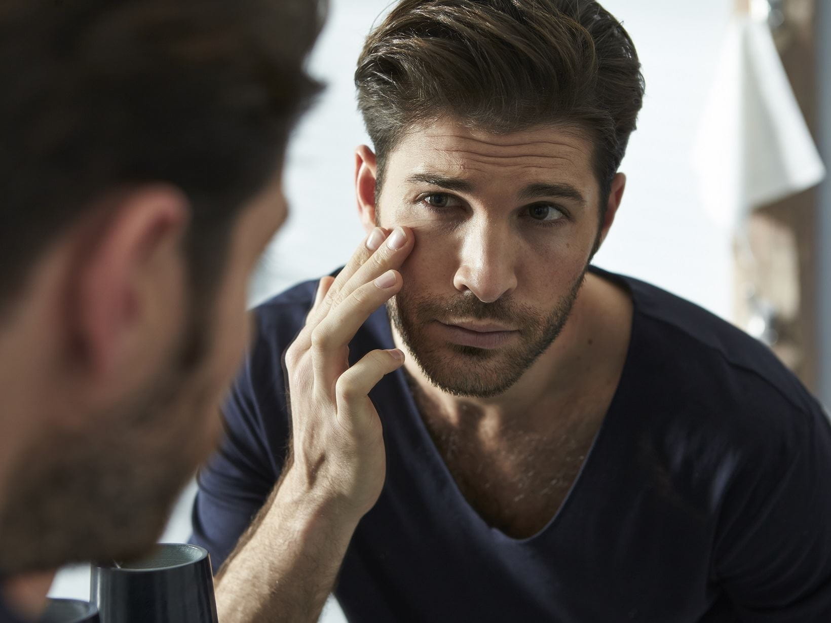 man using caffeine skin care products