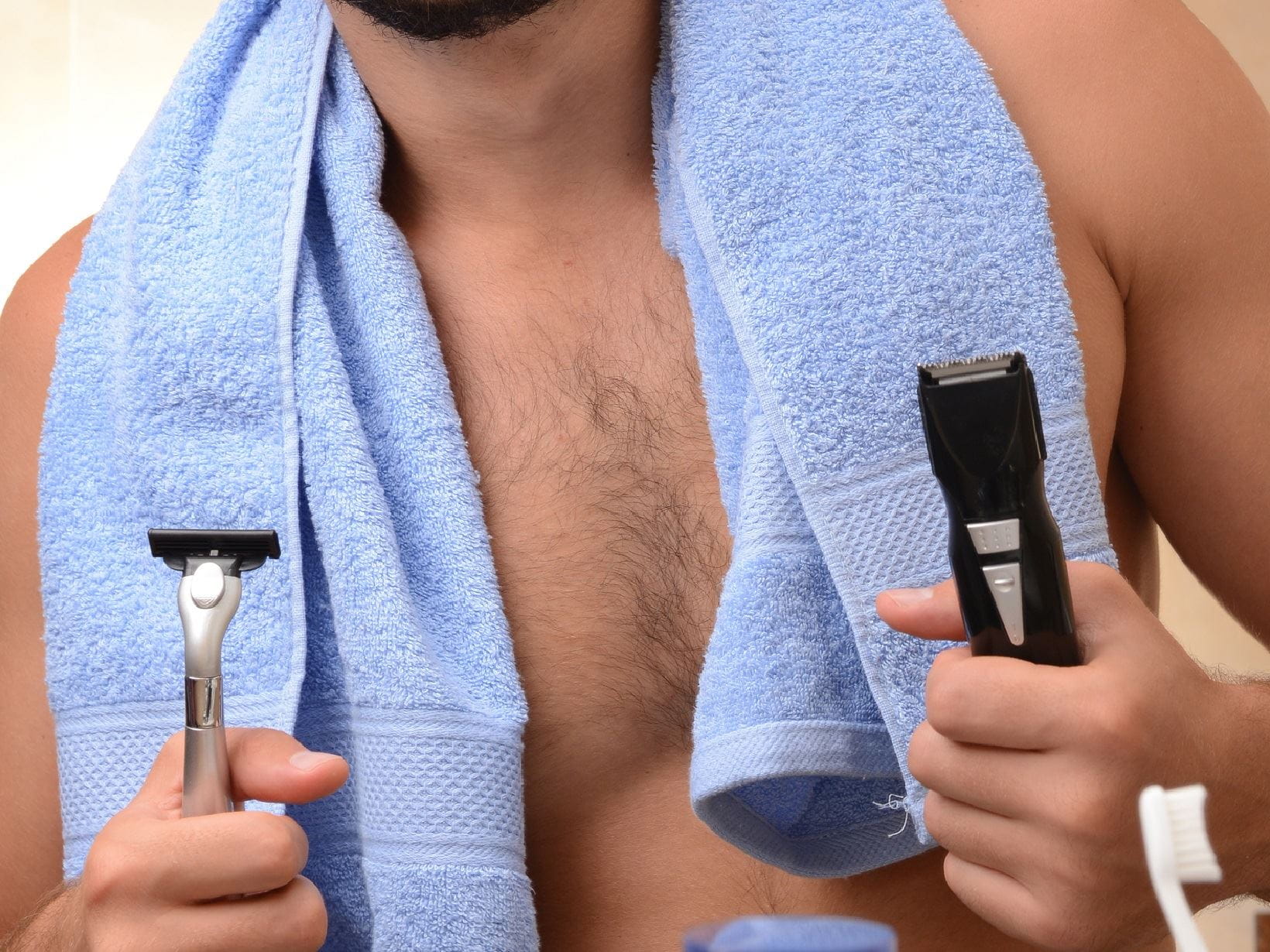 man holding 2 razors