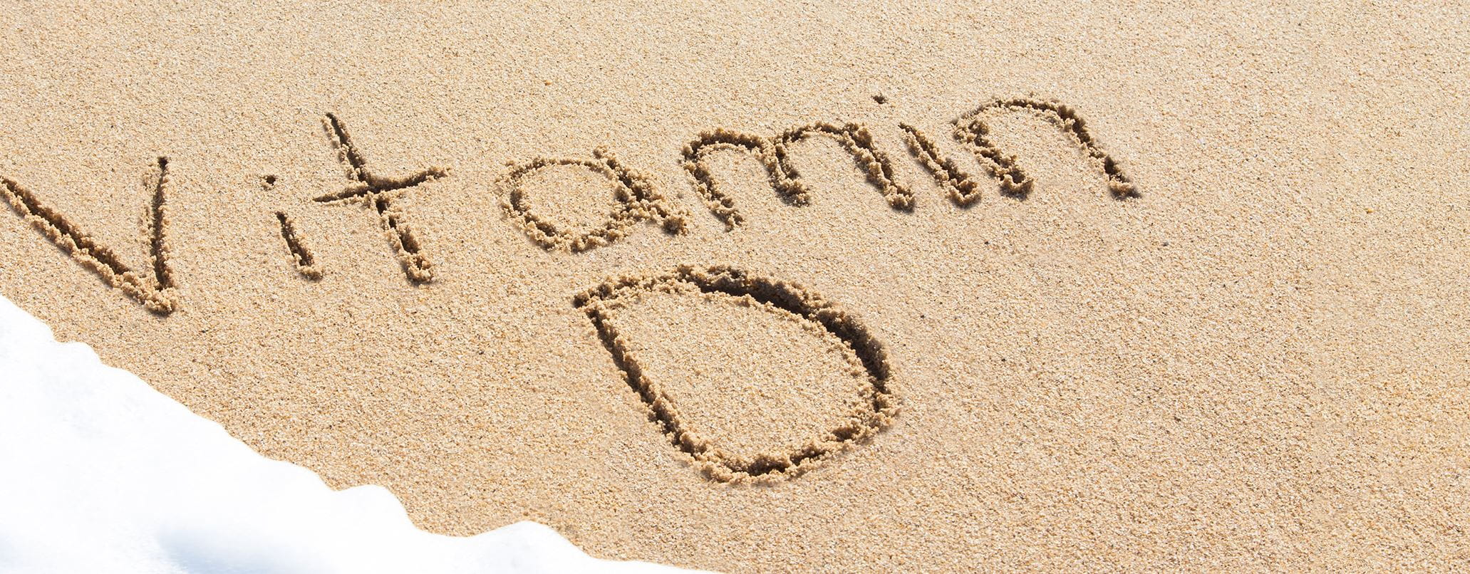 Vitamina D escrito na areia