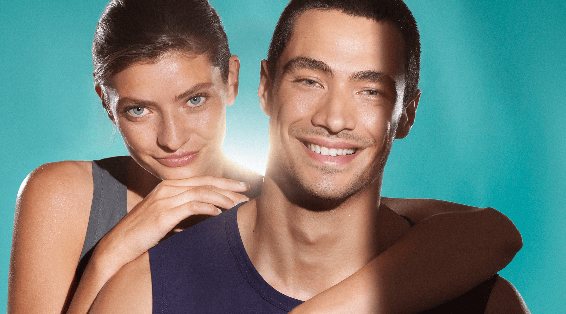 Close up of a woman and man, both of their faces show clear, blemish-free skin. They