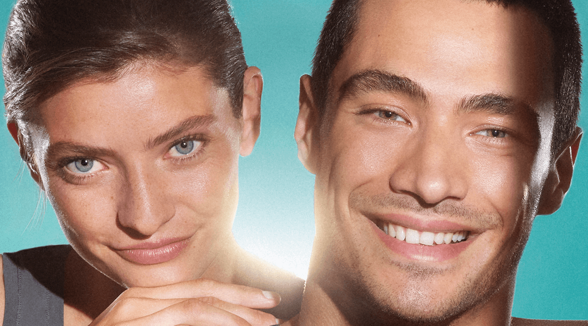 Close up of a woman and man, both of their faces show clear, blemish-free skin. They