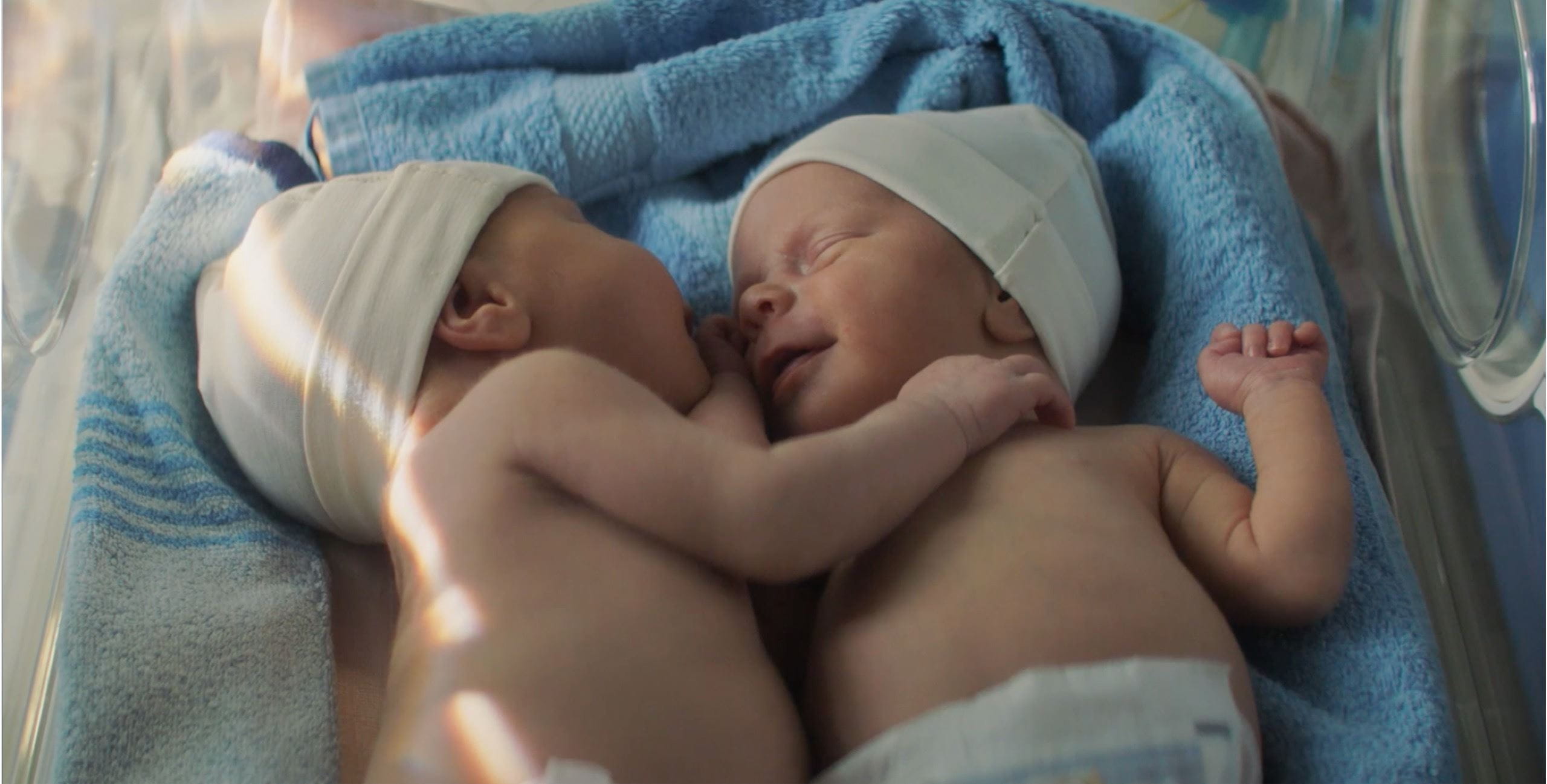 twin babies touching