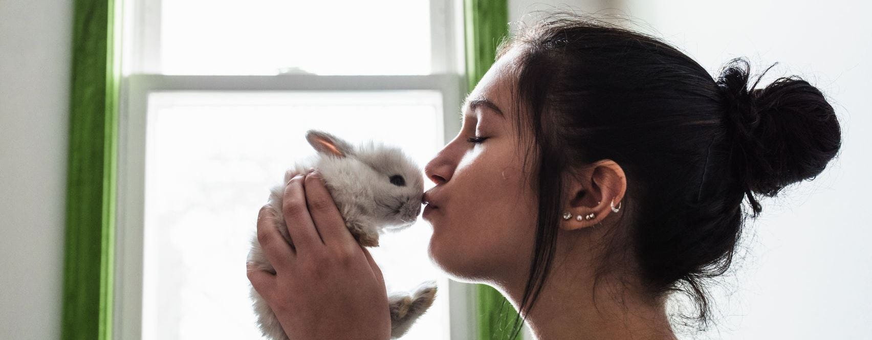 Woman kissing bunny rabbit