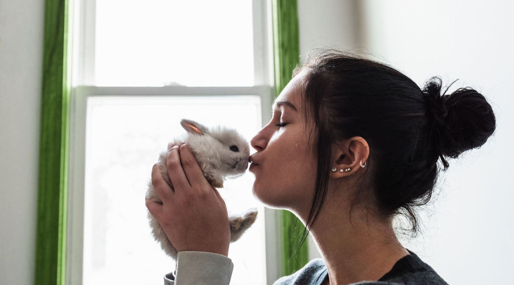 mulher a dar um beijo a um coelho