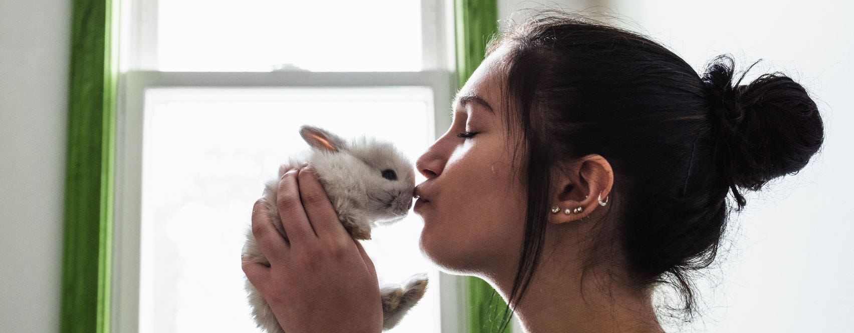 mulher a dar um beijo a um coelho