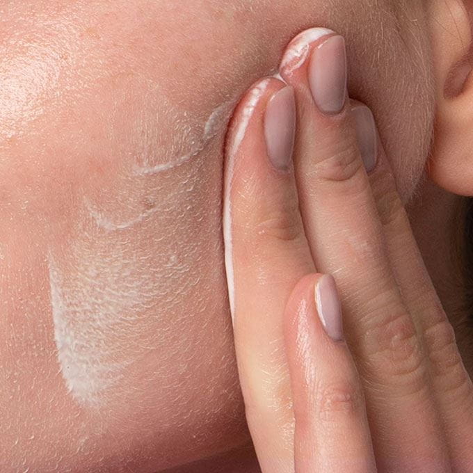 woman-applying-cream-on-face