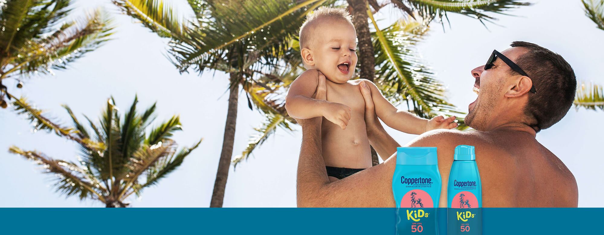 A view of a male model lifting a small child in the air with two Coppertone Kids Sunscreen products displayed in front and palm trees shown behind.