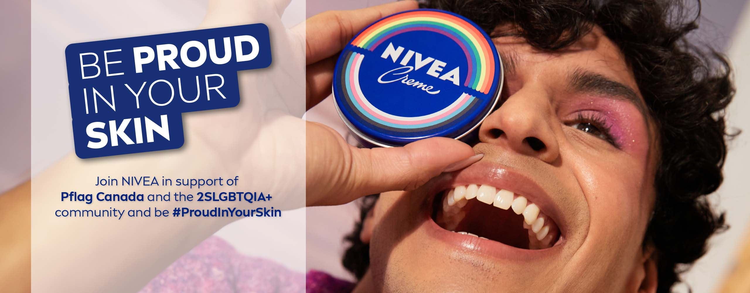 A view of a person looking up, smiling, while holding a NIVEA Creme Tin Pride limited edition  product over their right eye.