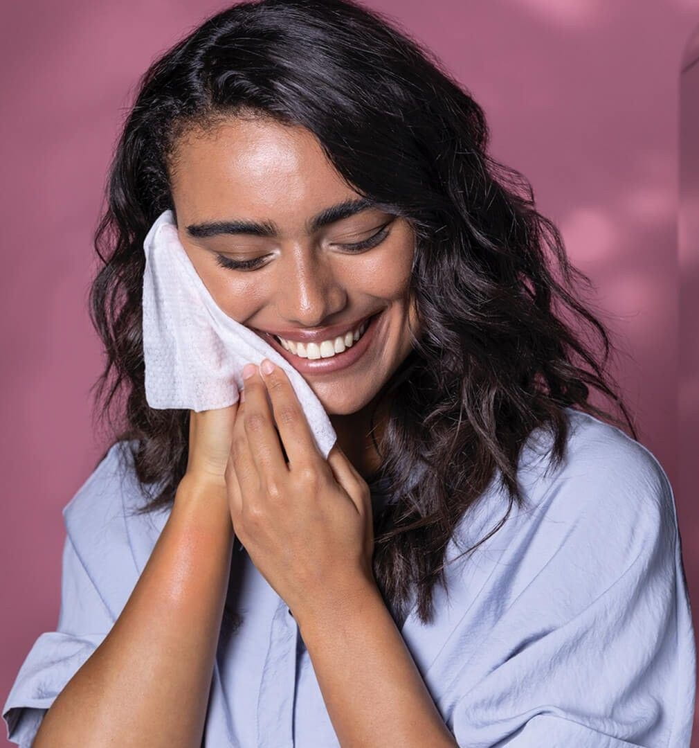 woman removing makeup with a face wipe