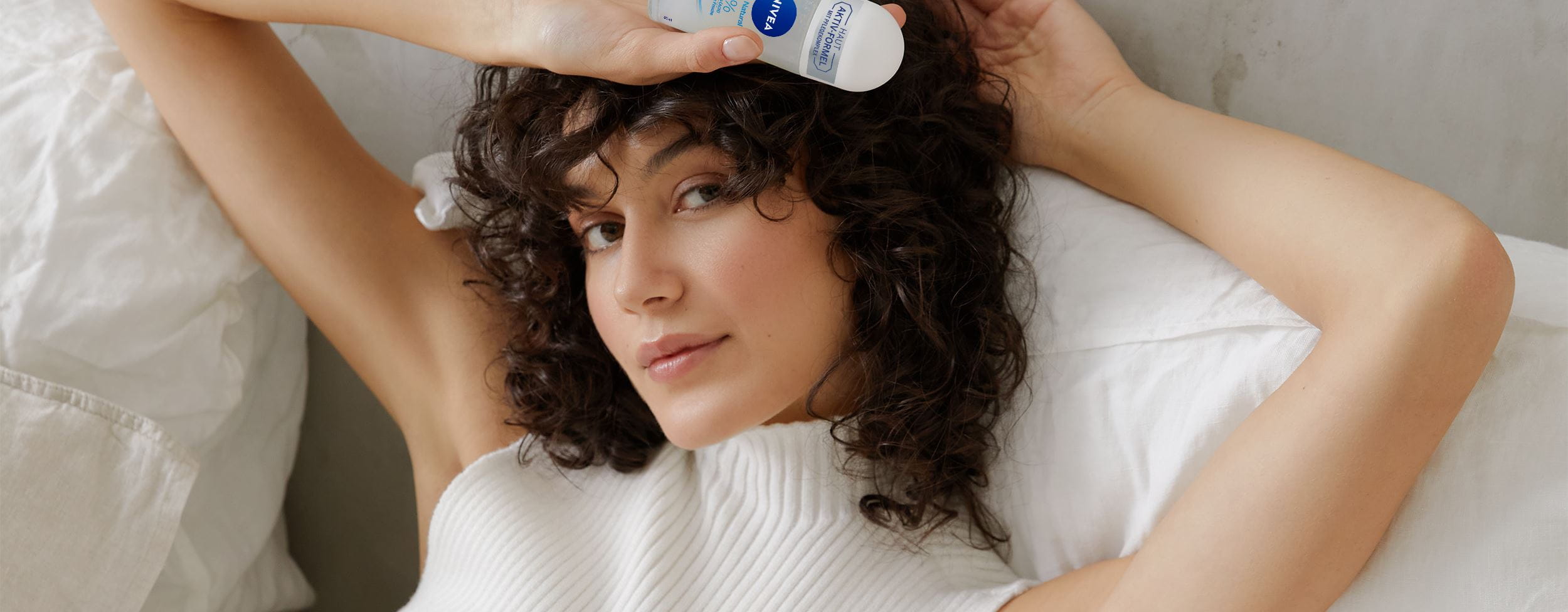 woman holding a Nivea roll-on