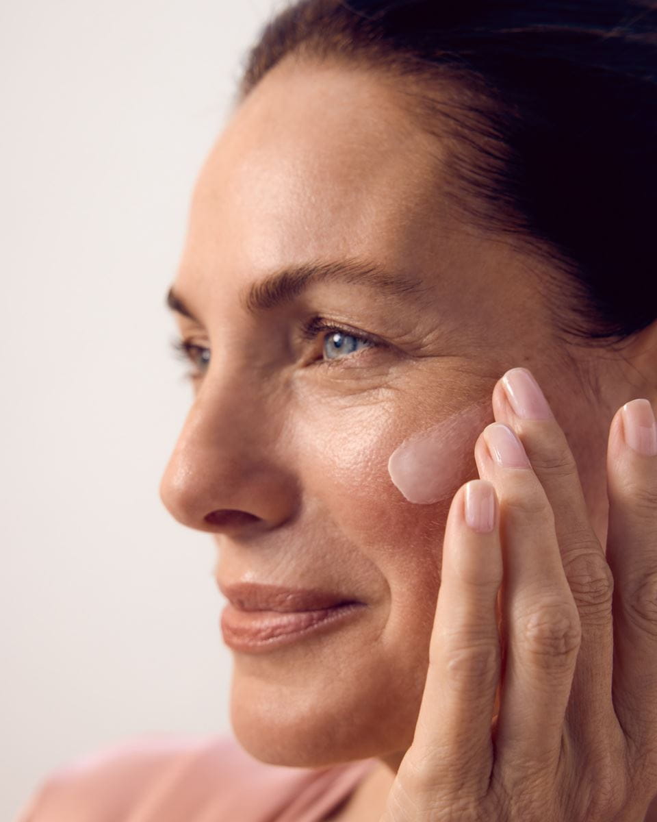 woman applying Nivea face cream on her face