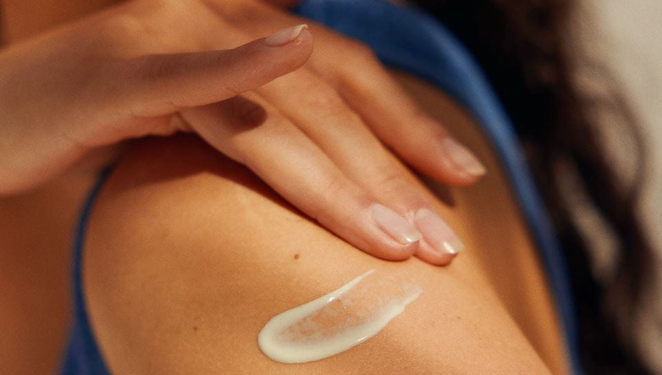 woman applying Nivea body lotion