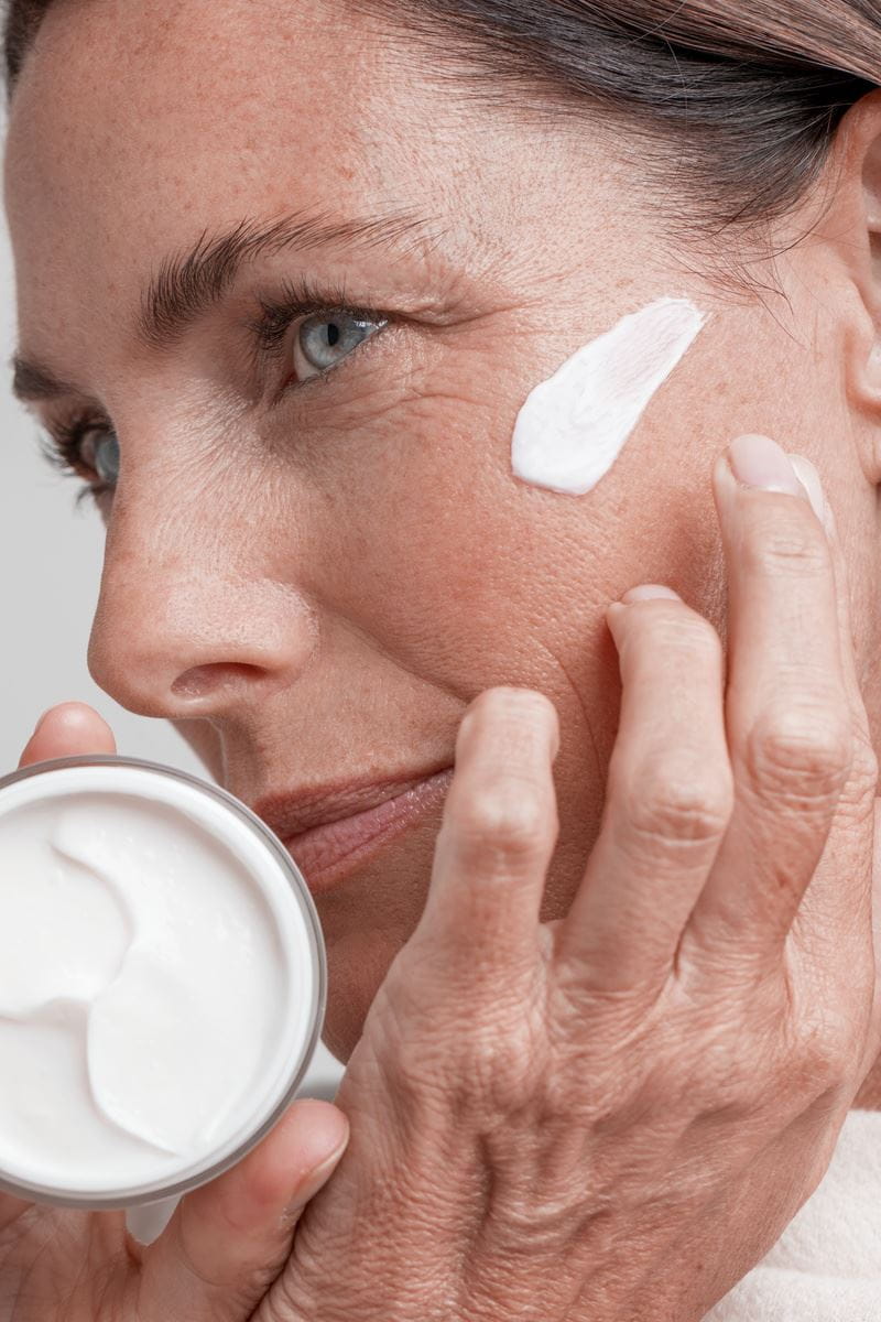 woman applying Nivea face cream