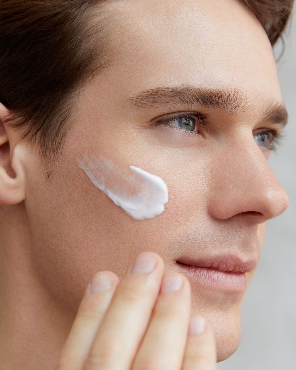 man applying Nivea face cream