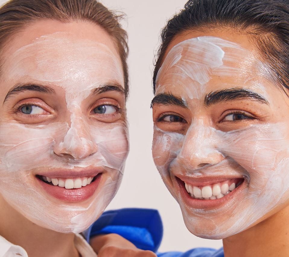 two girls applying Nivea face scrubs
