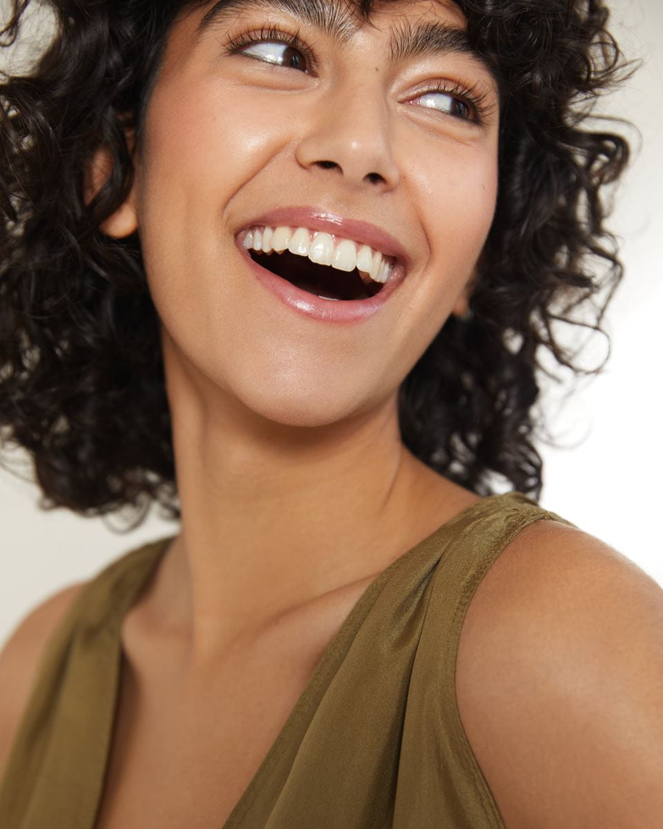 woman with short curly hair smiling