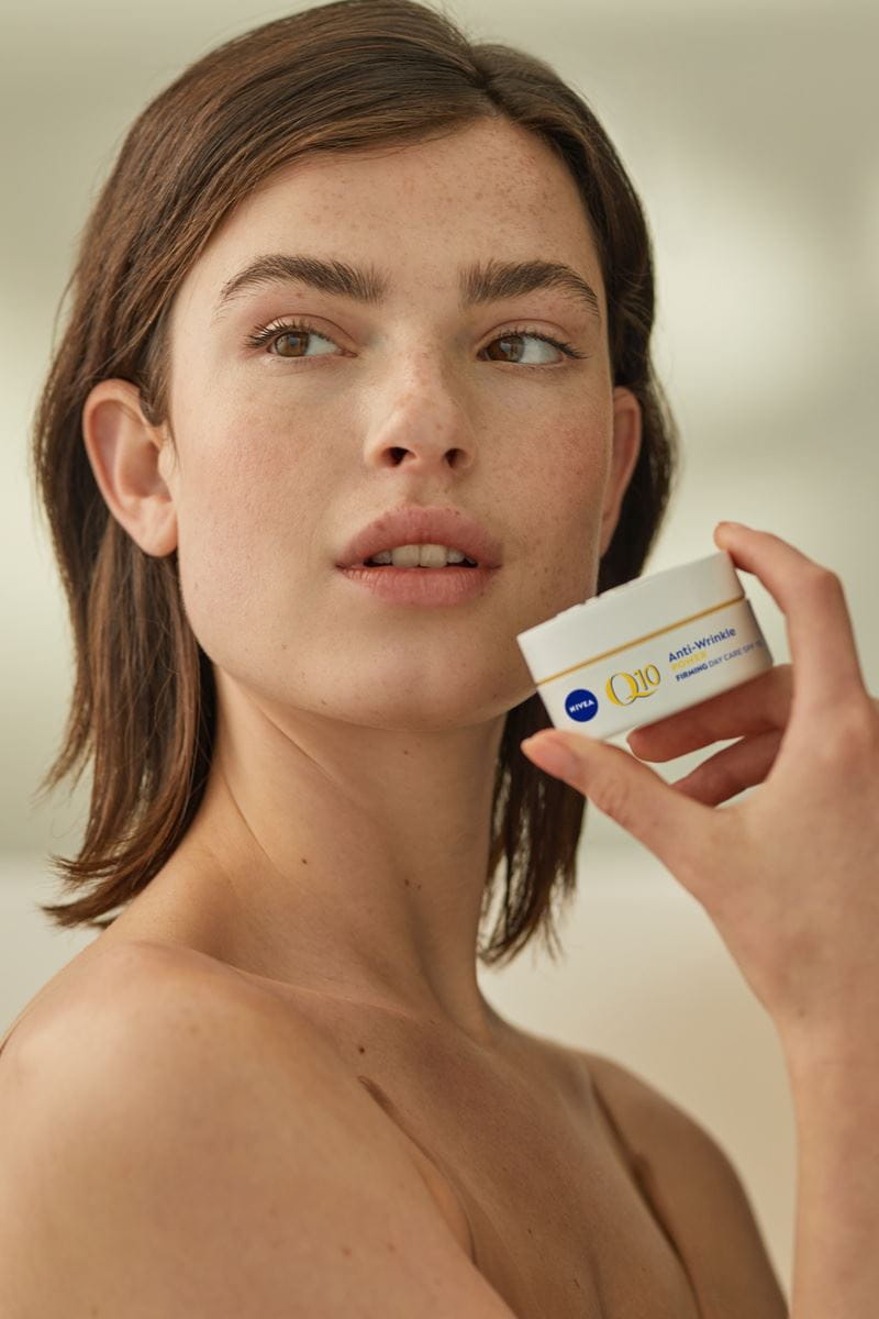 woman using Nivea Q10 Anti wrinkles cream