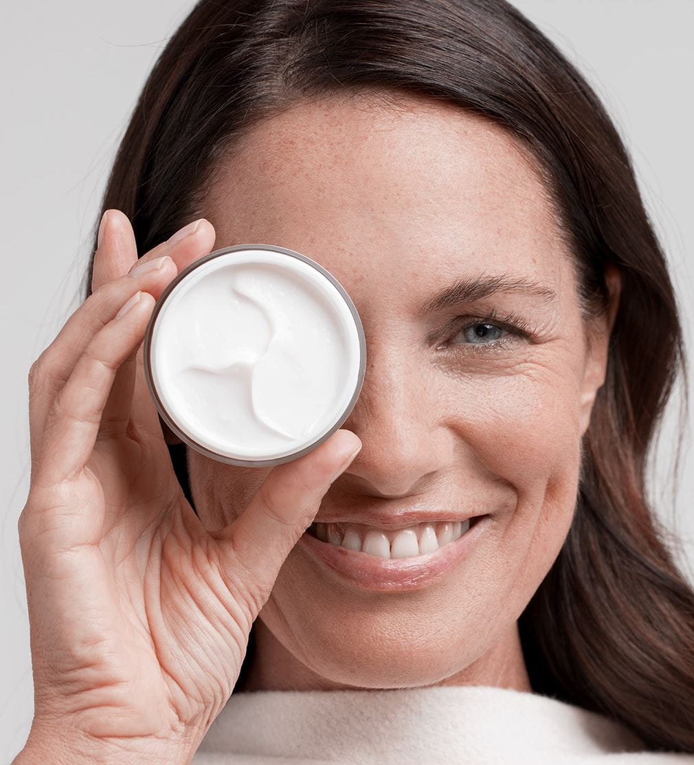 woman holding a Nivea face cream