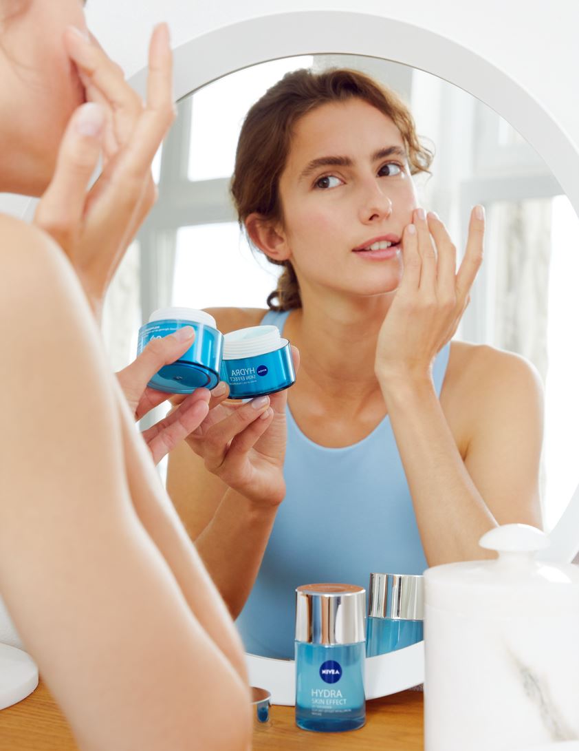 woman applying Nivea Hydra Skin Effect face cream
