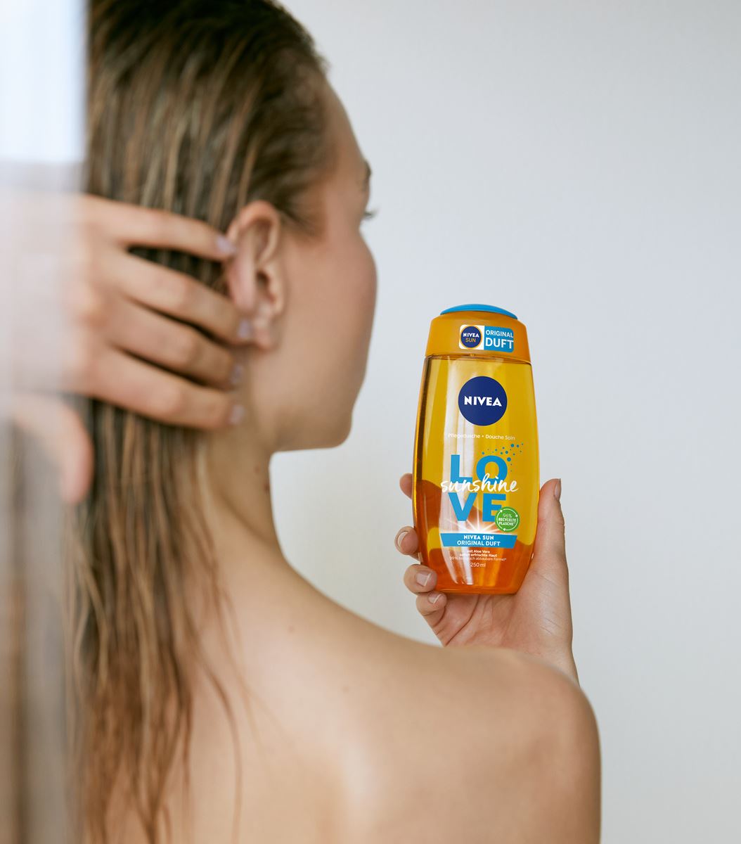 young woman using Nivea LOVE shower gel