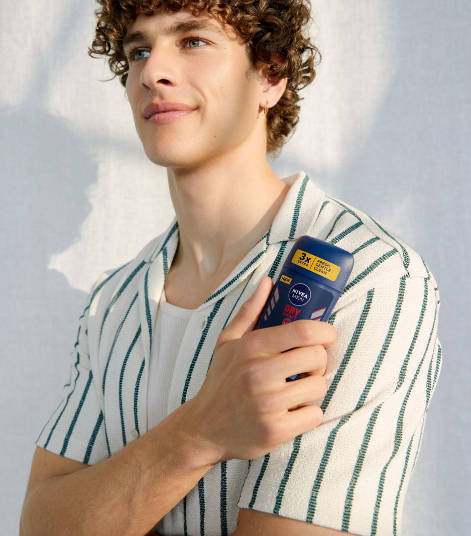 man holding a Nivea antiperspirant