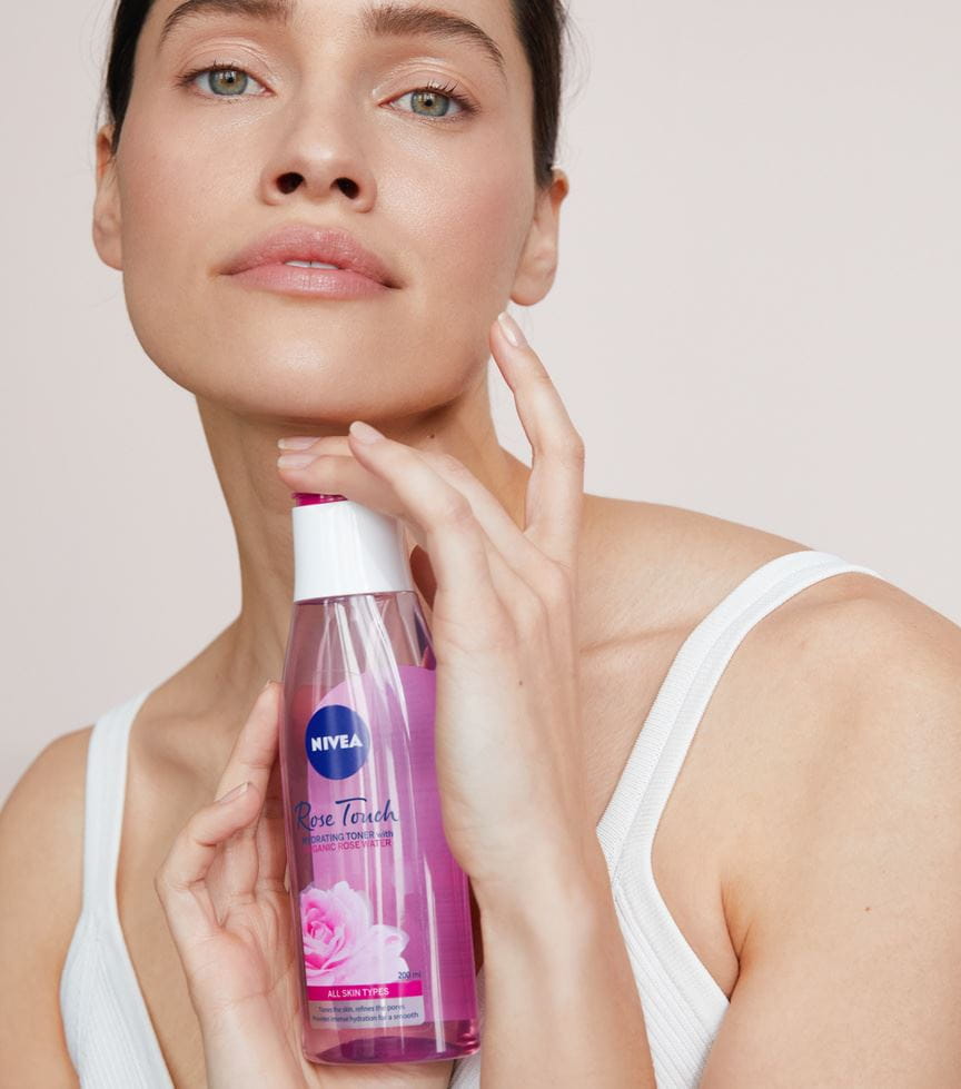 woman holding a Nivea Rose Touch Hydrating Toner