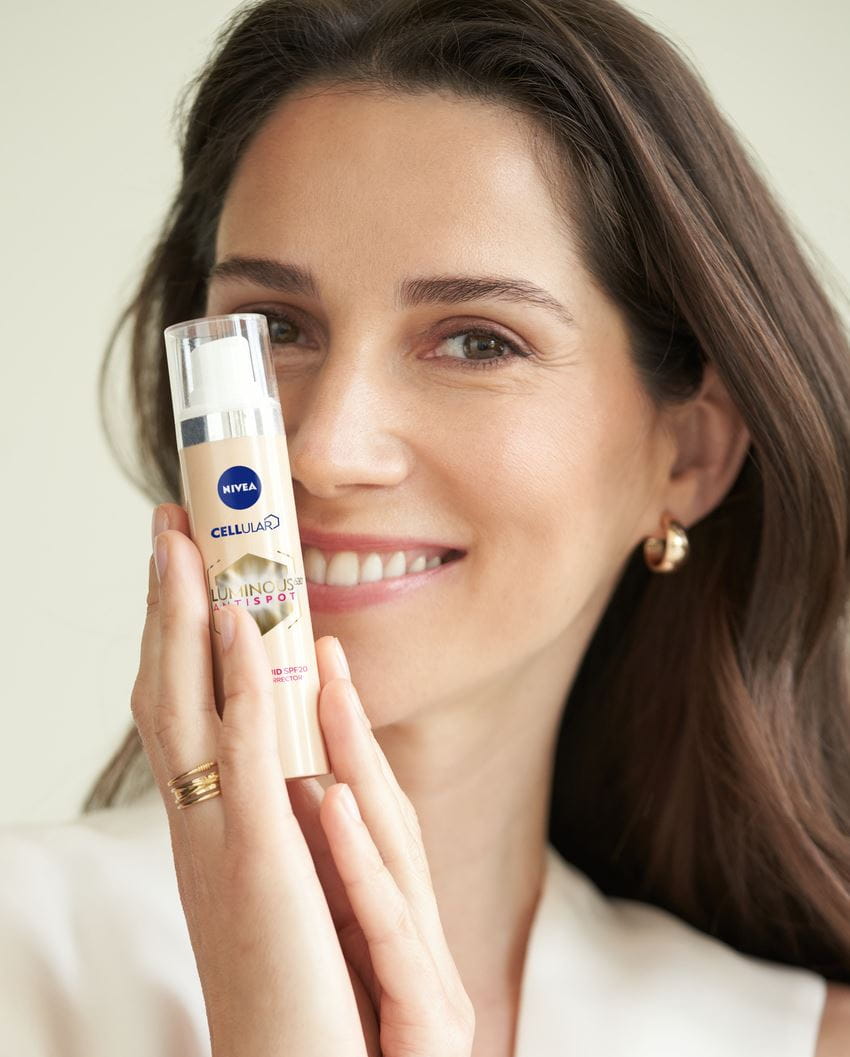 woman using Nivea Cellular Luminous Anti Spots face cream