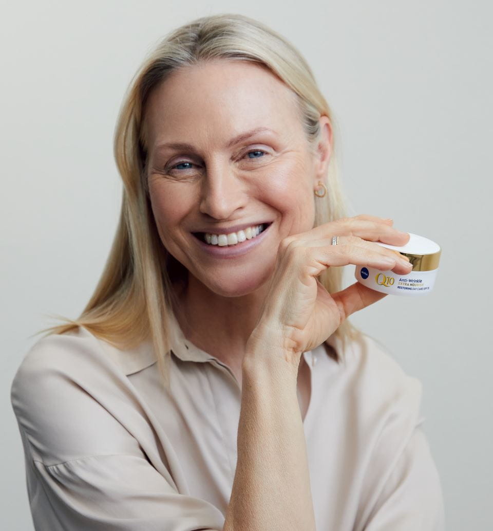 blonde woman holding a Nivea cream