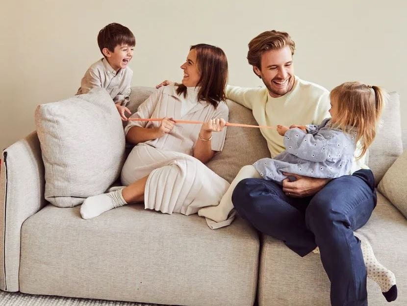 family playing on sofa