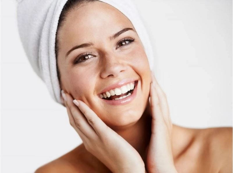 Smiling woman in white towel head