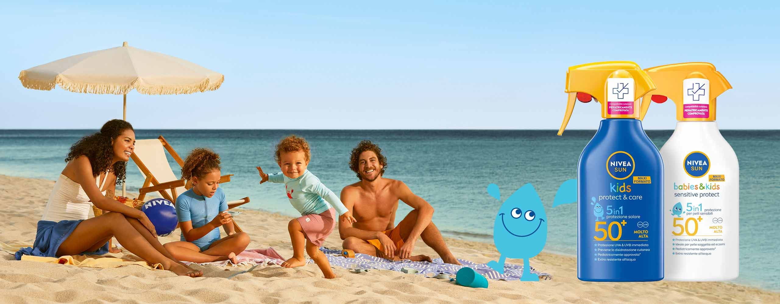 Parents with baby and child playing on beach with NIVEA Sunscreen
