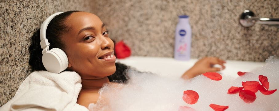 Lady in the bath tub with NIVEA Oil in Lotion product